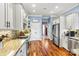 Well-lit kitchen includes stainless steel appliances, granite countertops, tile backsplash, and ample storage space at 5163 Meadow Park Ln, Hickory, NC 28602
