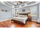 Comfortable main bedroom with natural light, tray ceiling, and hardwood floors; ready for rest and relaxation at 5163 Meadow Park Ln, Hickory, NC 28602