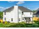 Back exterior featuring white siding, green grass, and pergola with outdoor seating at 5227 Eagle Creek Dr, Charlotte, NC 28269