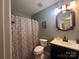 Bathroom with a shower and tub combination, stylish vanity, and updated fixtures at 5227 Eagle Creek Dr, Charlotte, NC 28269