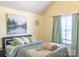 Bright bedroom with a cozy queen bed, soft blue bedding, and lots of natural light from the window at 5227 Eagle Creek Dr, Charlotte, NC 28269