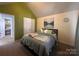 Bright bedroom with vaulted ceilings, decorative pillows, and cozy bedding at 5227 Eagle Creek Dr, Charlotte, NC 28269