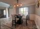 Charming dining room features a modern light fixture and seating for four at 5227 Eagle Creek Dr, Charlotte, NC 28269