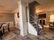View of the living room showcasing hardwood floors, a staircase, and neutral color palette at 5227 Eagle Creek Dr, Charlotte, NC 28269