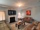 Comfortable living room featuring a fireplace, flat screen tv, hardwood floors, and bright light at 5227 Eagle Creek Dr, Charlotte, NC 28269