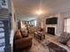 Bright living room with fireplace, flat screen tv, hardwood floors and view into the kitchen at 5227 Eagle Creek Dr, Charlotte, NC 28269