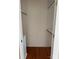Walk-in closet with hardwood floors and built-in shelving for optimal storage and organization at 524 Railroad Nw Dr, Concord, NC 28025