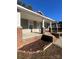 Inviting covered front porch with brick columns and landscaped flower beds, perfect for relaxing at 524 Railroad Nw Dr, Concord, NC 28025