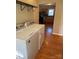 Laundry room with hardwood floors and washer/dryer hookups, offering convenience at 524 Railroad Nw Dr, Concord, NC 28025