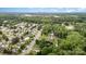 An aerial view showcases the neighborhood, the beautiful tree coverage, and city view at 5625 Linda Vista Ln, Charlotte, NC 28216