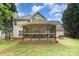 A home's backyard with a screened-in porch and a barbecue grill, perfect for outdoor entertaining at 5625 Linda Vista Ln, Charlotte, NC 28216