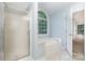 Bathroom boasting a soaking tub, separate shower, and large window to enjoy the outside view at 5625 Linda Vista Ln, Charlotte, NC 28216