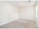 Bedroom boasting plush carpeting, a ceiling light and a window providing natural light at 5625 Linda Vista Ln, Charlotte, NC 28216