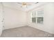Cozy bedroom featuring plush carpeting, a ceiling fan and a window with blinds at 5625 Linda Vista Ln, Charlotte, NC 28216