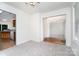 Open dining area with carpet, leading to kitchen with tile backsplash and adjoining rooms at 5625 Linda Vista Ln, Charlotte, NC 28216