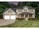 Inviting two-story brick home featuring a two-car garage and manicured front yard at 5625 Linda Vista Ln, Charlotte, NC 28216
