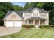 Inviting two-story brick home with a well-manicured lawn and attached two-car garage at 5625 Linda Vista Ln, Charlotte, NC 28216