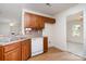 Well-lit kitchen featuring warm cabinetry, stainless appliances, and easy access to the dining area at 5625 Linda Vista Ln, Charlotte, NC 28216