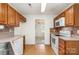 Spacious kitchen with wood cabinets and modern appliances, connected to dining area and sink at 5625 Linda Vista Ln, Charlotte, NC 28216