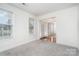 Bright living room with large window and neutral carpet at 5625 Linda Vista Ln, Charlotte, NC 28216