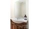 Stylish powder room with dark wood vanity and a modern sink, offering a convenient space at 5625 Linda Vista Ln, Charlotte, NC 28216
