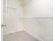 Bright walk-in closet featuring neutral carpeting and ample shelving for organization at 5625 Linda Vista Ln, Charlotte, NC 28216