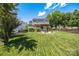 Expansive backyard featuring a well-manicured lawn, mature trees, and a cozy patio perfect for outdoor entertaining at 6107 Raisin Tree Ln, Charlotte, NC 28215
