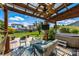 Outdoor covered patio featuring a ceiling fan, hot tub, and comfortable seating at 6107 Raisin Tree Ln, Charlotte, NC 28215