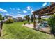Grassy backyard with a patio, hammock, and pergola at 6107 Raisin Tree Ln, Charlotte, NC 28215