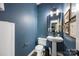 Compact bathroom with a pedestal sink and modern fixtures at 6107 Raisin Tree Ln, Charlotte, NC 28215