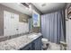 Neutral tone bathroom with granite vanity and shower/tub combo at 6107 Raisin Tree Ln, Charlotte, NC 28215