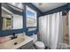 Bathroom with navy blue walls, shower-tub and window for natural light at 6107 Raisin Tree Ln, Charlotte, NC 28215