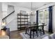 Dining area with chandelier, large table and chairs, a bookshelf and natural light from the window at 6107 Raisin Tree Ln, Charlotte, NC 28215
