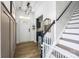 Welcoming entryway featuring paneled walls, a staircase, and modern light fixture at 6107 Raisin Tree Ln, Charlotte, NC 28215