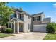 Charming two-story home featuring a welcoming front porch and attached two-car garage on a sunny day at 6107 Raisin Tree Ln, Charlotte, NC 28215