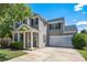 Charming two-story home showcasing a well-maintained lawn, attached two-car garage, and covered front porch at 6107 Raisin Tree Ln, Charlotte, NC 28215