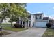 Charming two-story home with gray siding, mature trees, and a well-maintained front yard and driveway at 6107 Raisin Tree Ln, Charlotte, NC 28215