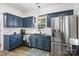 Bright kitchen with stainless steel appliances, sleek granite countertops and dark blue cabinets at 6107 Raisin Tree Ln, Charlotte, NC 28215