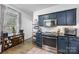 Well-lit kitchen with stainless steel appliances, dark-blue cabinets, and stylish accessories at 6107 Raisin Tree Ln, Charlotte, NC 28215