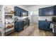 Open kitchen with stylish dark-blue cabinets, stainless appliances and hardwood floors, great for cooking at 6107 Raisin Tree Ln, Charlotte, NC 28215