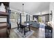Spacious dining area with a large table, flowing into an inviting living room with ample natural light at 6107 Raisin Tree Ln, Charlotte, NC 28215