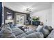 Spacious living room with a comfortable gray sectional, fireplace, and French doors at 6107 Raisin Tree Ln, Charlotte, NC 28215