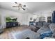 Open-concept living room with gray sofa, TV, and view of dining area at 6107 Raisin Tree Ln, Charlotte, NC 28215