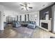 Open floor plan showcasing living room, dining area, and fireplace with gray sectional at 6107 Raisin Tree Ln, Charlotte, NC 28215