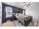 Main bedroom with modern dark wood furniture and natural light from two windows at 6107 Raisin Tree Ln, Charlotte, NC 28215