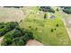 Aerial view of the property featuring open land, trees, surrounding homes, and paved roads at 6201 New Hope Church Rd, Marshville, NC 28103