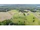 Scenic aerial view displays the property surrounded by lush greenery, fields, and neighborhood homes at 6201 New Hope Church Rd, Marshville, NC 28103