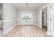 Light-filled dining room with modern flooring and large window at 6201 New Hope Church Rd, Marshville, NC 28103