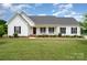 Charming single-story home featuring a covered front porch, manicured lawn, and classic architectural details at 6201 New Hope Church Rd, Marshville, NC 28103