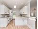 Well-lit kitchen features an island, white cabinets, and modern appliances at 6201 New Hope Church Rd, Marshville, NC 28103